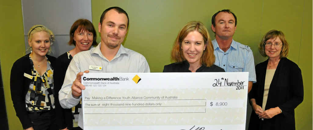 Commonwealth bank staff present MADYACA members with a cheque to help at-risk youth. Commonwealth bank staff present MADYACA members with a cheque to help at-risk youth.